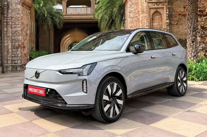 Volvo EX90 electric SUV outside a stone archway